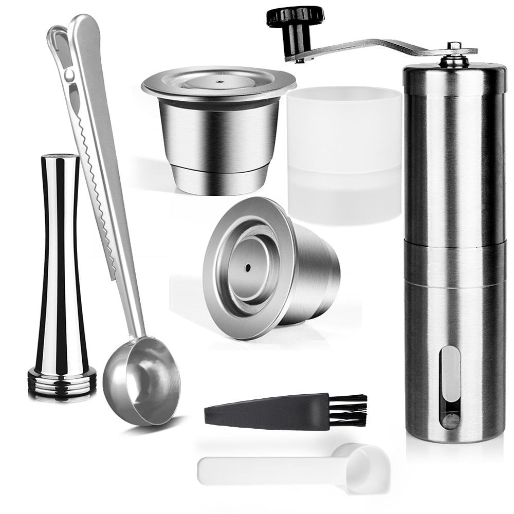 2 stainless steel coffee capsules, 1 temper, 1 grinder, 1 metal scoop, and 1 Filling Holder. All on a white background. Includes a free brush and scoop.